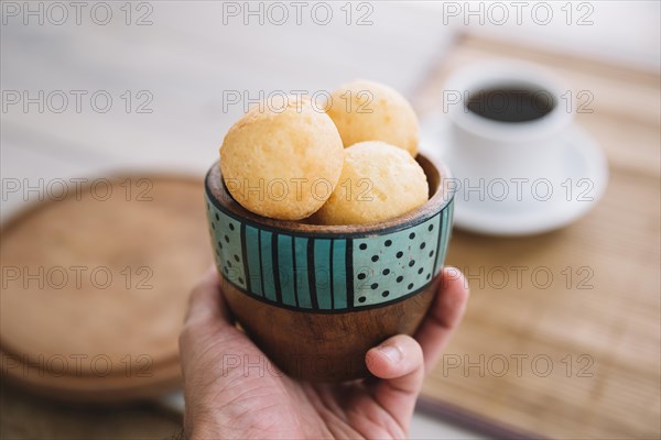 Person holding cheese balls bowl