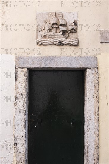 Relief of a sailing ship on a house wall in Lisbon