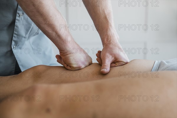 Male physiotherapist massage session with female patient