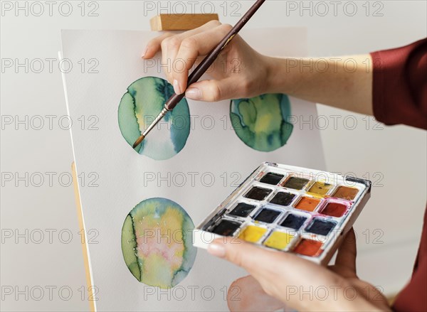 Young artist painting with watercolors