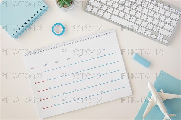 Flat lay planner calendar with blue accessories