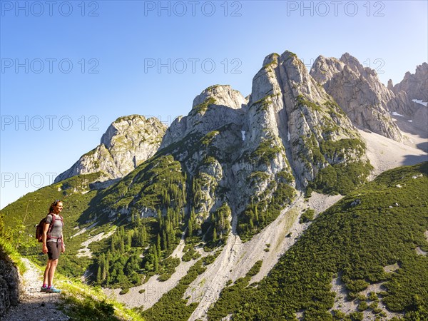 Woman in front of the peaks of the Gosaukamm