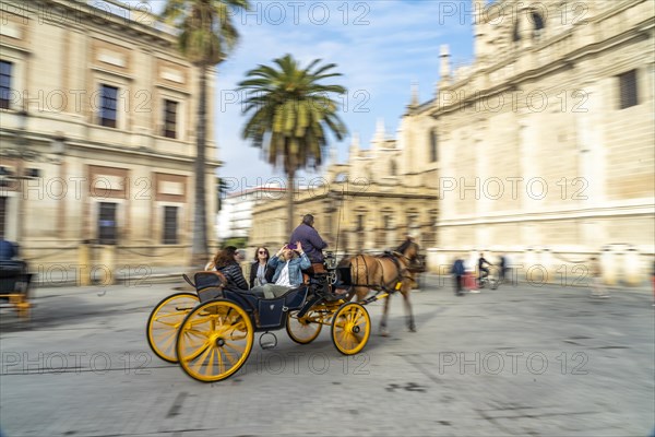 Horse-drawn carriage with tourists in the old town of Seville Andalusia
