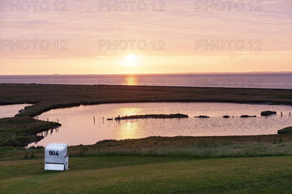 A beach chair on the meadow at sunset on Hallig Langeness