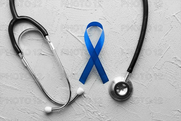 Stethoscope around colon cancer ribbon