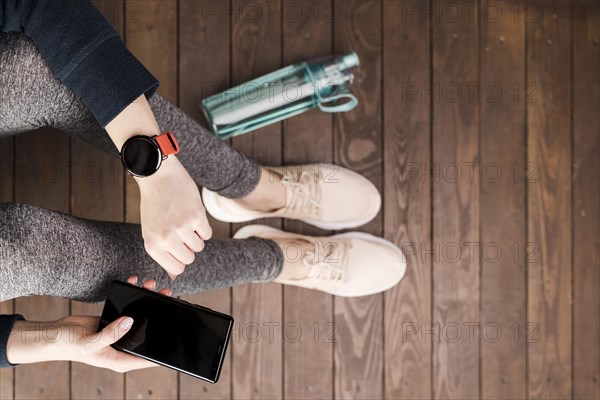 Top view woman sportswear holding mobile phone