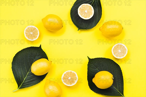 Flat lay tropical lemons leaves