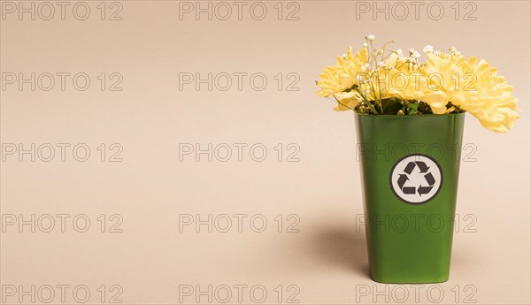 Copy space recycle bin with flowers