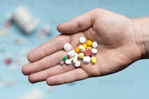 Flat lay hand holding assortment pills