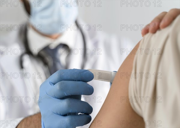 Man putting bandage young woman s arm