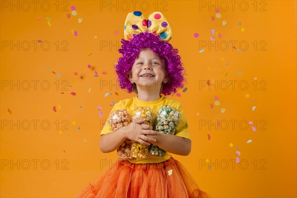 Girl with clown costume candy