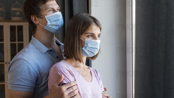 Man woman wearing face mask home