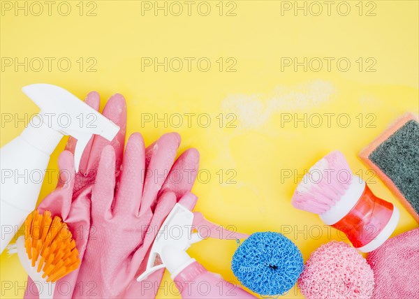 Spray bottle brush sponge pink gloves yellow backdrop