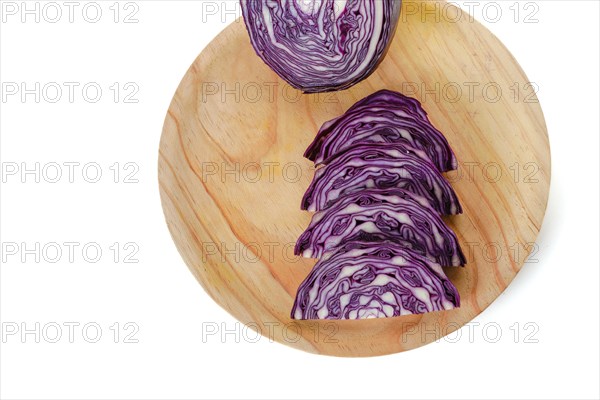 Sliced purple cabbage on a wooden board with white background