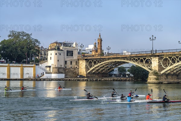 Kayaks on the Guadalquivir River at the Puente de Isabel II Bridge