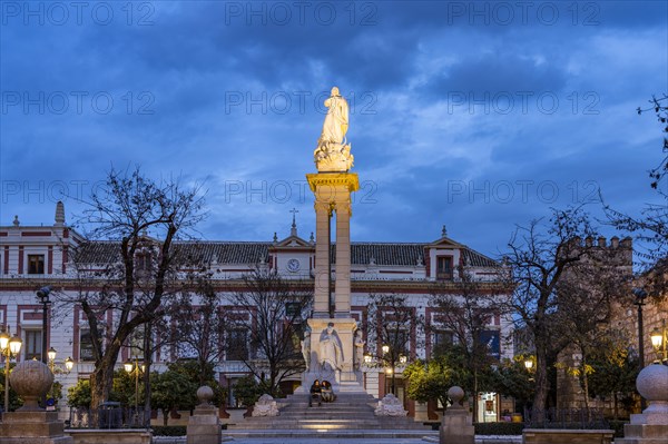 Inmaculada statue in the Plaza del Triunfo square at dusk