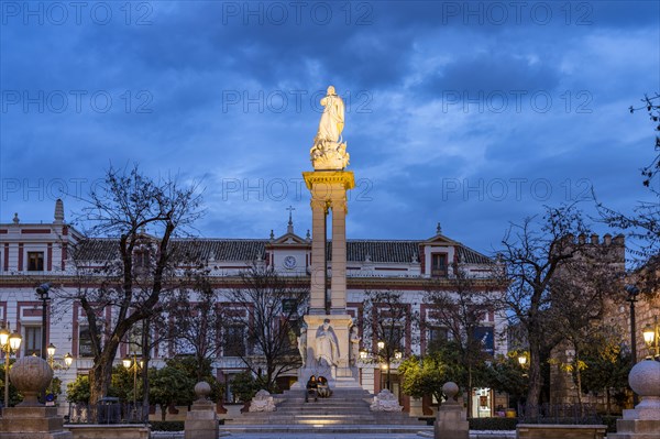 Inmaculada statue in the Plaza del Triunfo square at dusk
