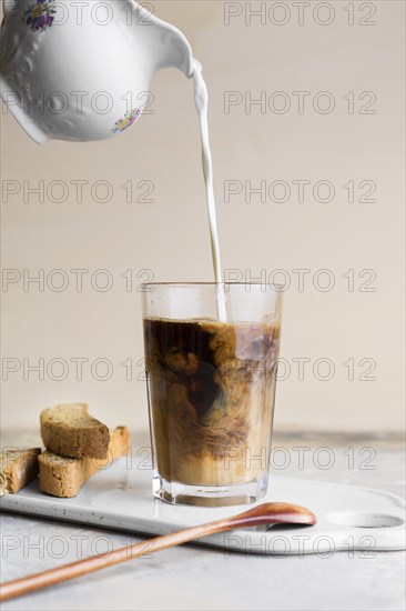 Front view milk being poured frappe slices bread with seeds