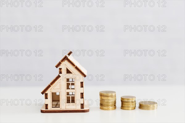 Stacked coins wooden home