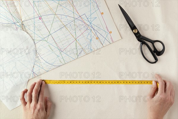 Close up tailor using measuring tape