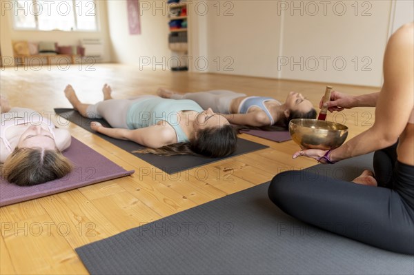 Female yoga teacher teaching class 8