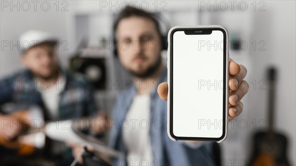 Medium shot man holding smartphone