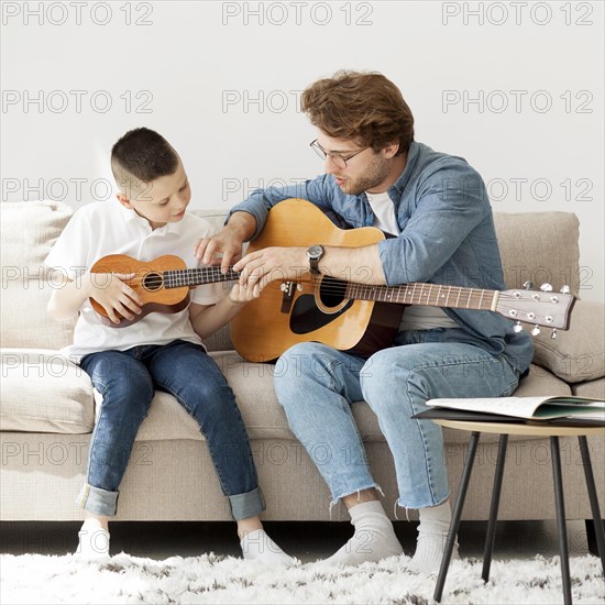 Tutor boy learning accoustic guitar ukulele