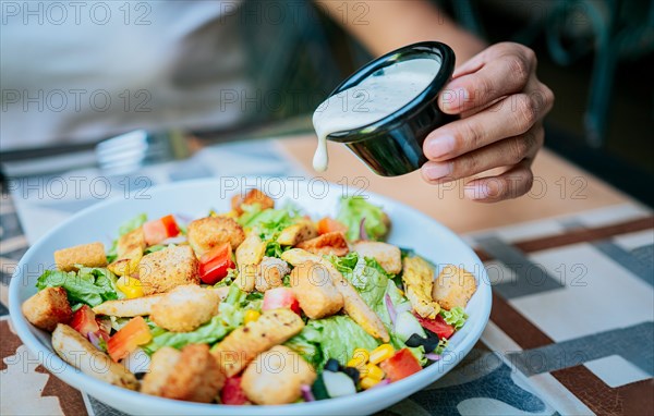 Close up of hand preparing a vegetable salad. Concept of healthy food and lifestyle