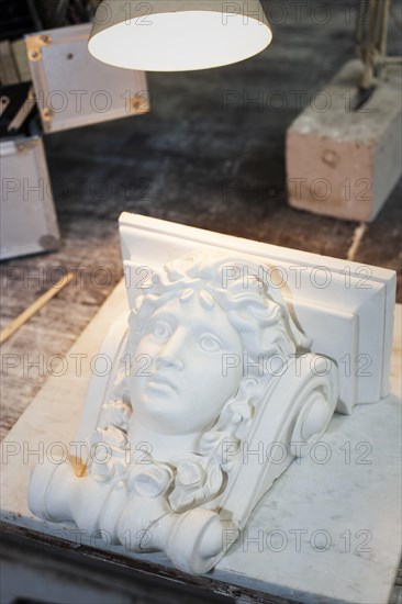 Female head in stucco on a workbench