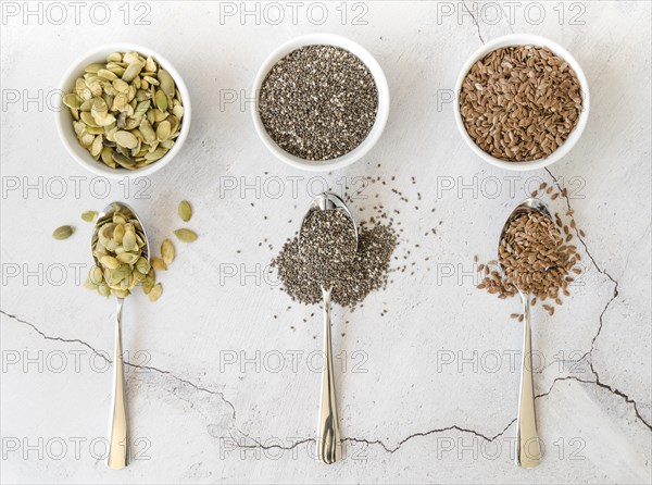 Bowls with various seeds spoons