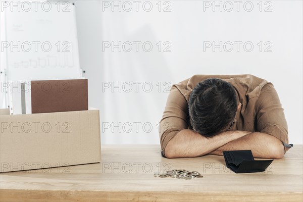 Medium shot depressed man table