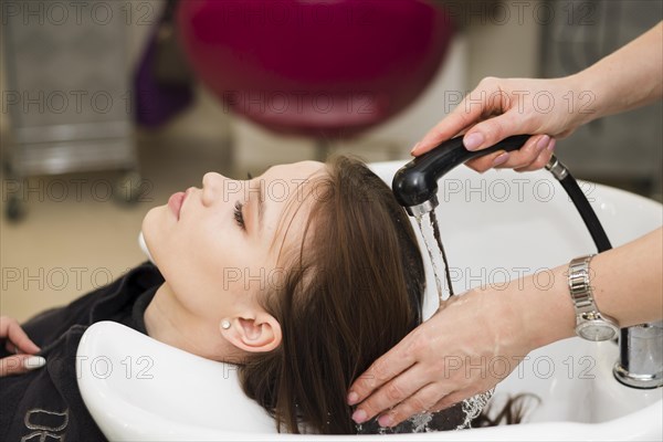 Blonde girl getting her hair washed