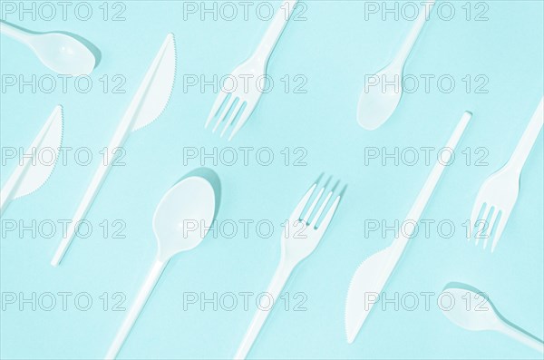 White disposable cutlery composition turquoise background