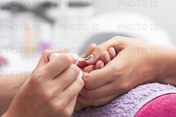 Woman having her manicure done close up salon