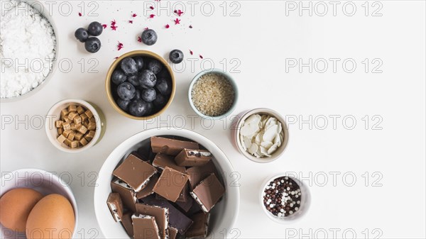 Different type ingredients making cake white background