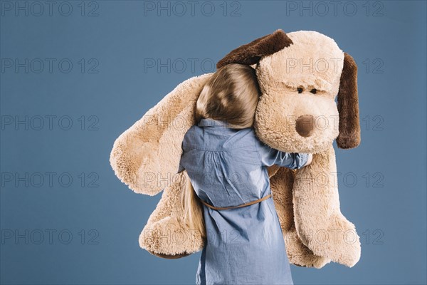 Girl hugging plush toy