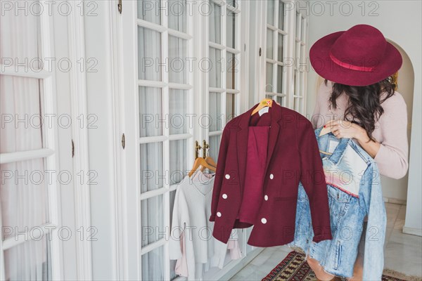 Stylish young woman looking burgundy suit