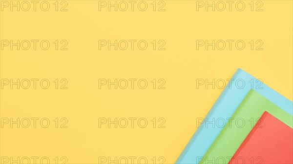 Yellow background with paper sheets corner