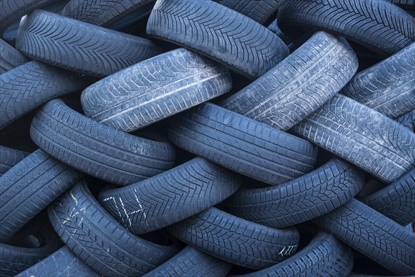 Pile of worn old tyres from passenger cars