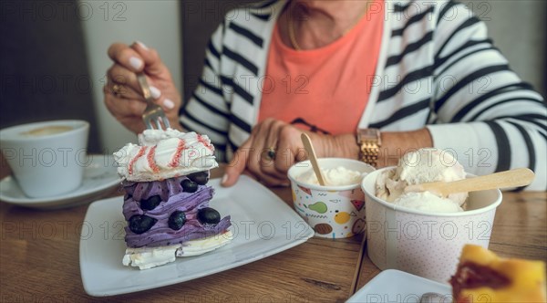 In a cafe. Purple blueberry cake