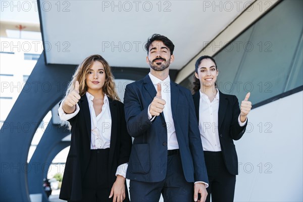 Team architects making thumbs up gesture