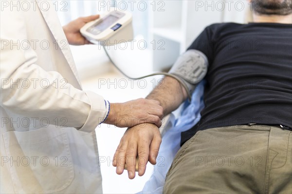 Doctor taking patient's blood pressure