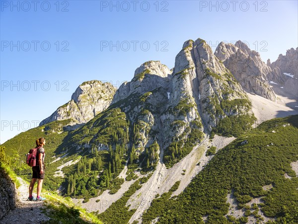 Woman enjoying the view of the peaks of the Gosaukamm