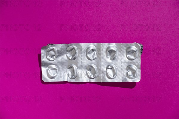 Empty tablet blister pack against a monochrome background