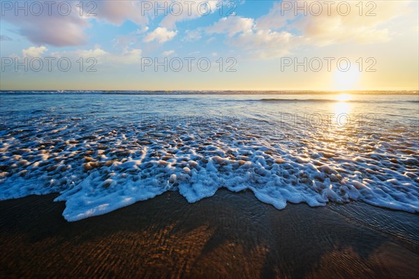 Atlantic ocean sunset with surging waves at Fonte da Telha beach