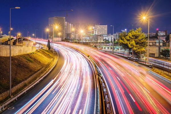 Long Exposure of street traffic near Campolide station in the evening with car lights trails. Lisbon