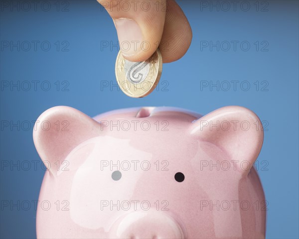 Person placing coin piggy bank