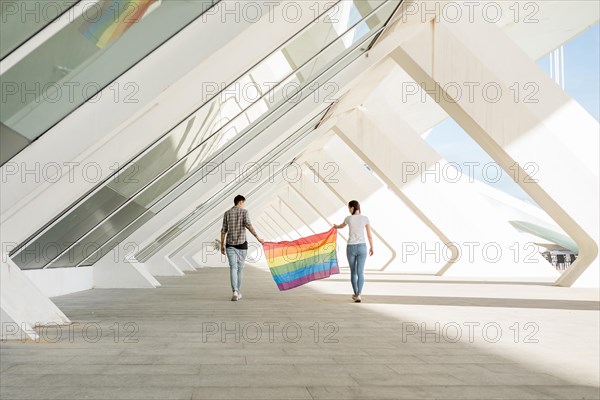 Lgbt couple holding rainbow flag