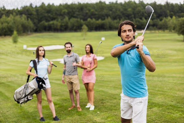 Friends playing golf field