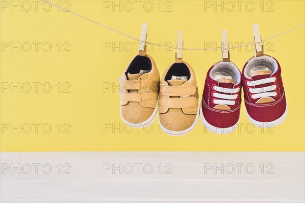 Newborn concept with two shoes clothesline